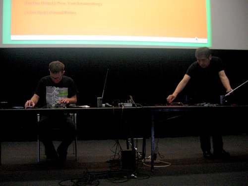 Two people at a desk.