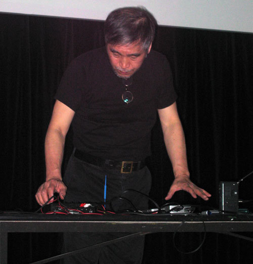 A man working controls at a desk.