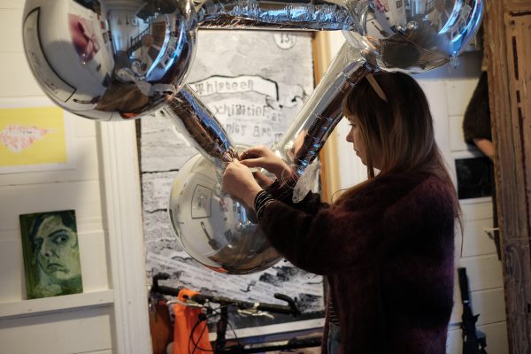 A woman tinkering with a balloon.