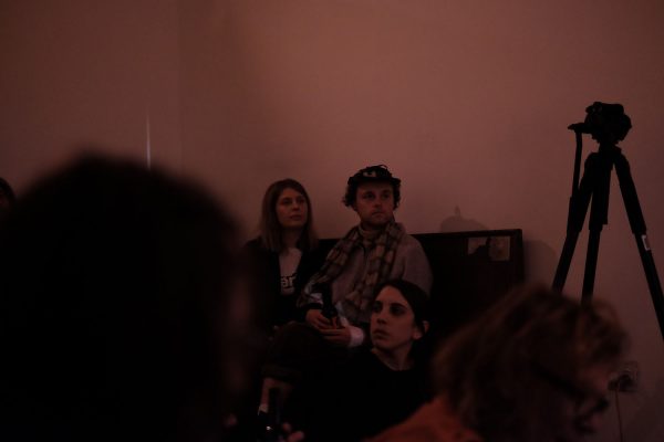 Multiple people sitting in a room.