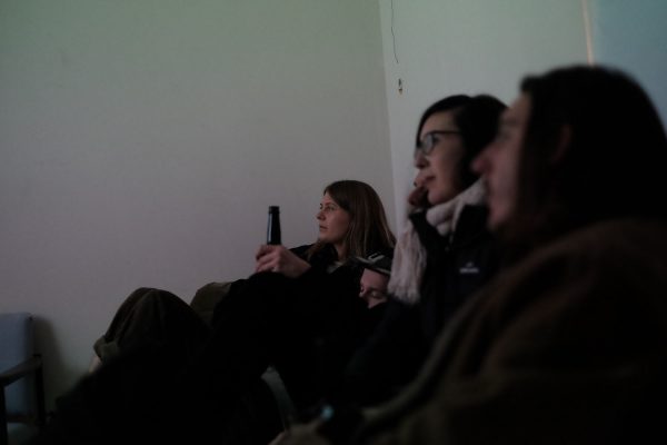 Three people sitting in a room.