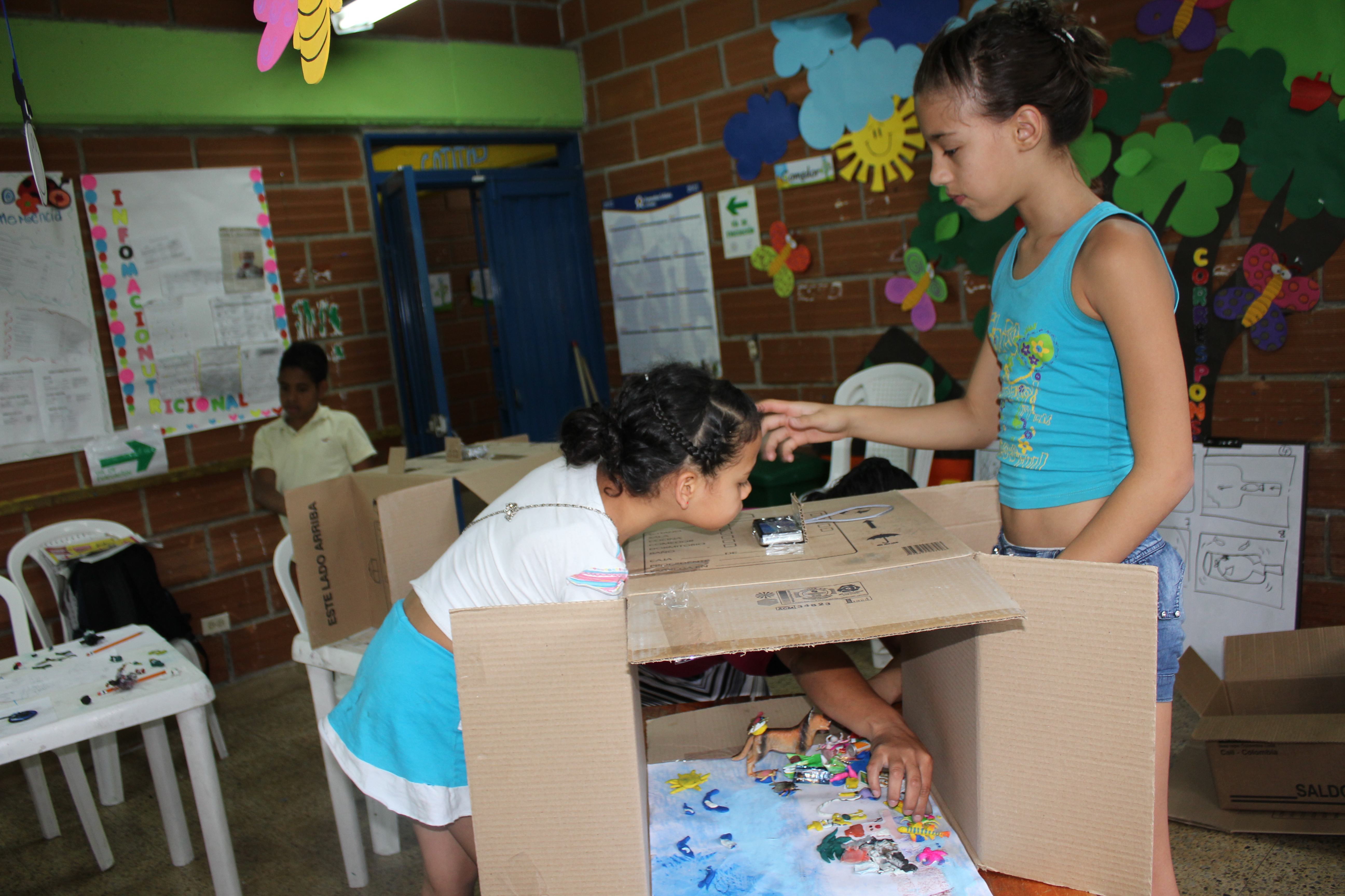 Two people interacting with a table.