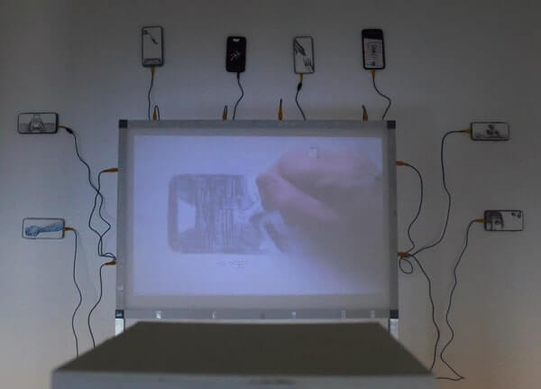A large screen connected with cords to 8 smaller screens